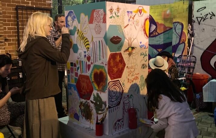People painting a mural at the event 2022